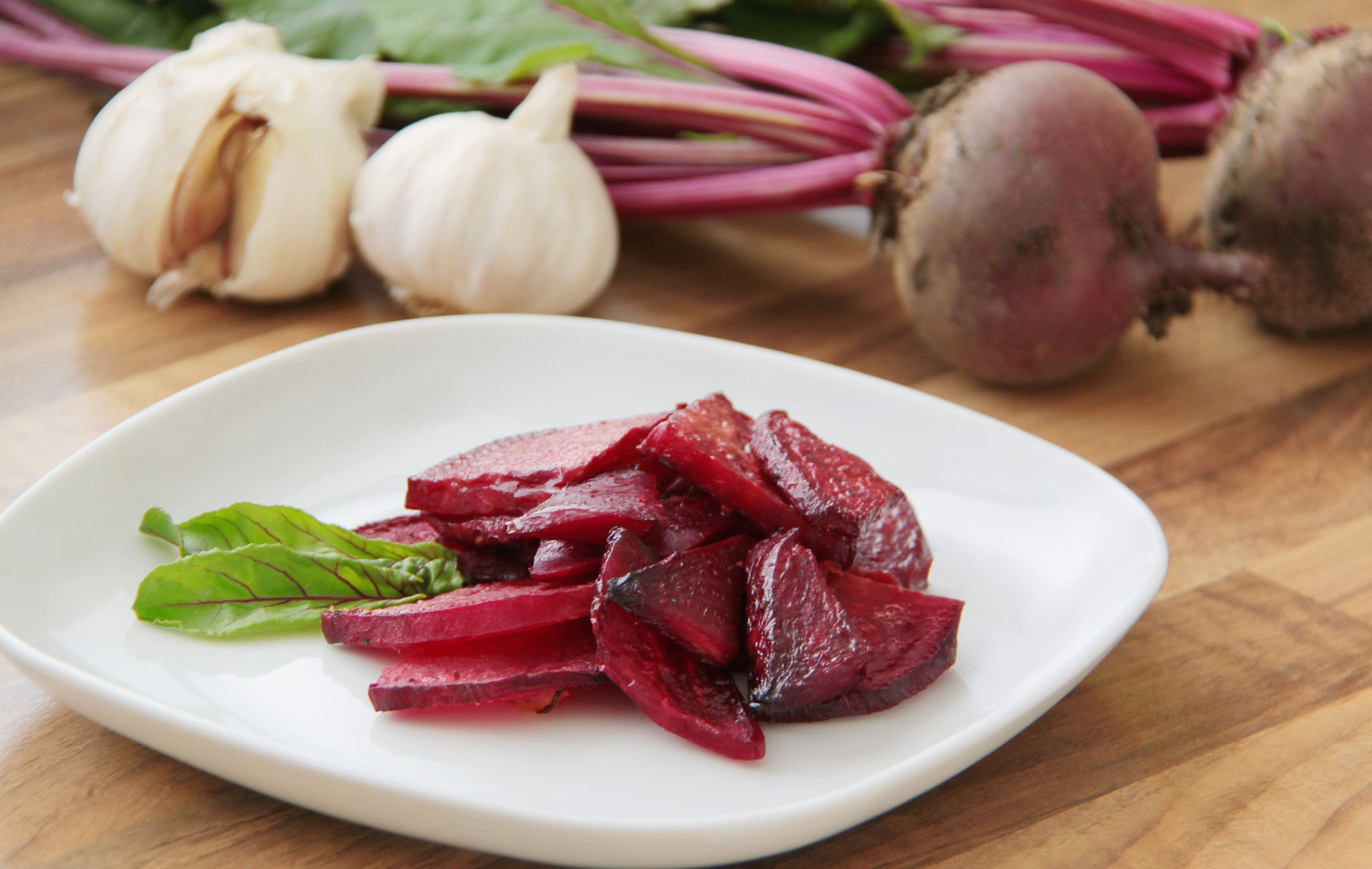 Roasted-slices-of-beetroot-served-on-a-white-plate-scaled